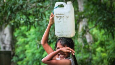 A girl carrying a water container on her head