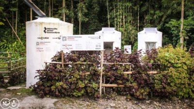 Water tanks and sanitation facilities beside a planted garden