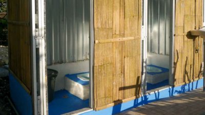 Open doors revealing two newly built toilet cubicles