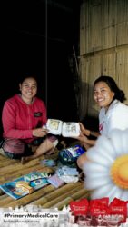A health agent from Kawan Sehat is providing medical care to a patient in a remote village.