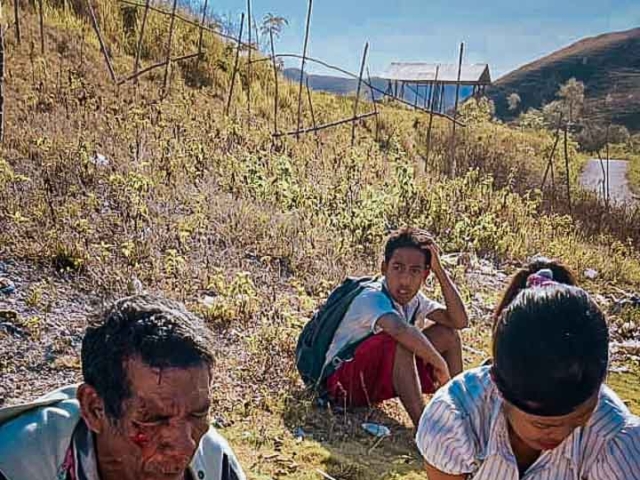 A health agent from Kawan Sehat is providing medical care to a patient in a remote village.