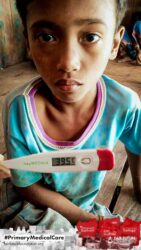 A health agent from Kawan Sehat is providing medical care to a patient in a remote village.