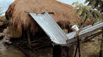 Family in rural community using makeshift tools to collect unsafe water for daily use.