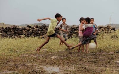 Simple Joy: Kids Play Barefoot Football in the Rain