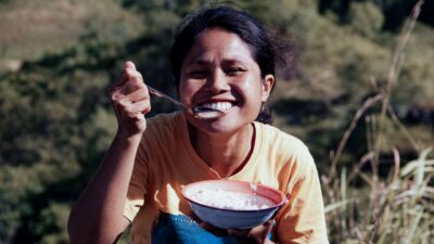 People in ultra-rural communities laughing together, demonstrating the health benefits of smiling and social connection.