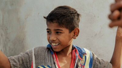 People in ultra-rural communities laughing together, demonstrating the health benefits of smiling and social connection.