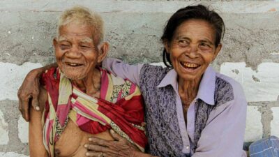 People in ultra-rural communities laughing together, demonstrating the health benefits of smiling and social connection.