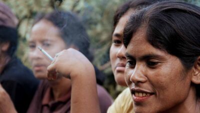 A mother and child exposed to secondhand smoke in a rural village emphasizing the dangers of passive smoke