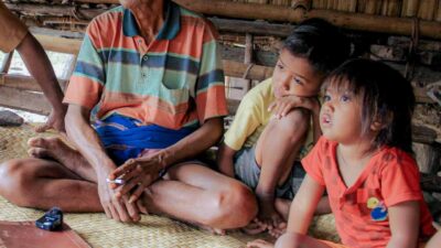 A mother and child exposed to secondhand smoke in a rural village emphasizing the dangers of passive smoke