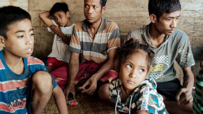 A mother and child exposed to secondhand smoke in a rural village emphasizing the dangers of passive smoke