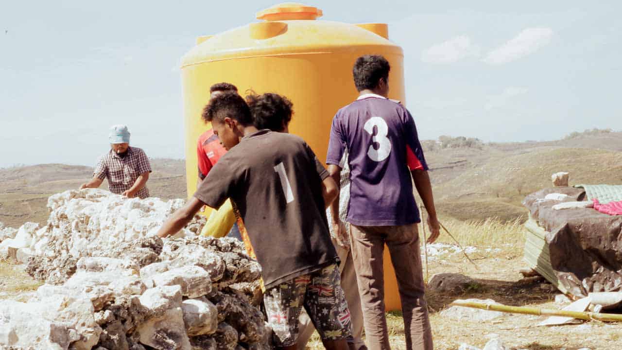 Children receiving clean water and medical care funded by small donations to Fair Future Foundation.