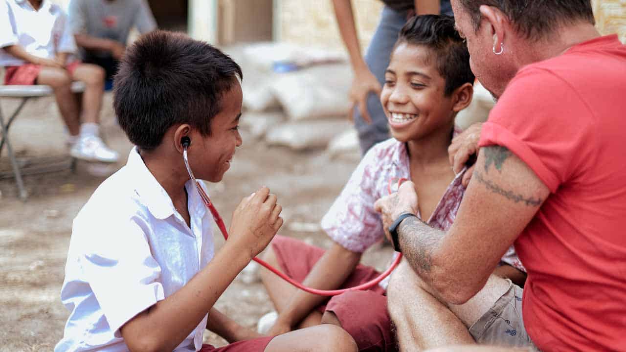 Children receiving clean water and medical care funded by small donations to Fair Future Foundation.