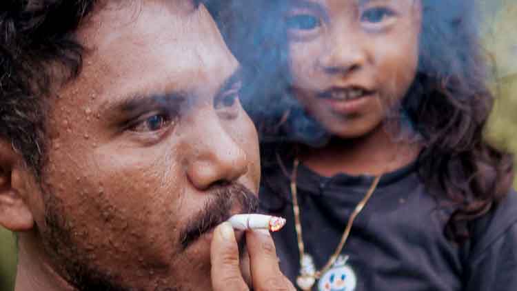 A mother and child exposed to secondhand smoke in a rural village emphasizing the dangers of passive smoke