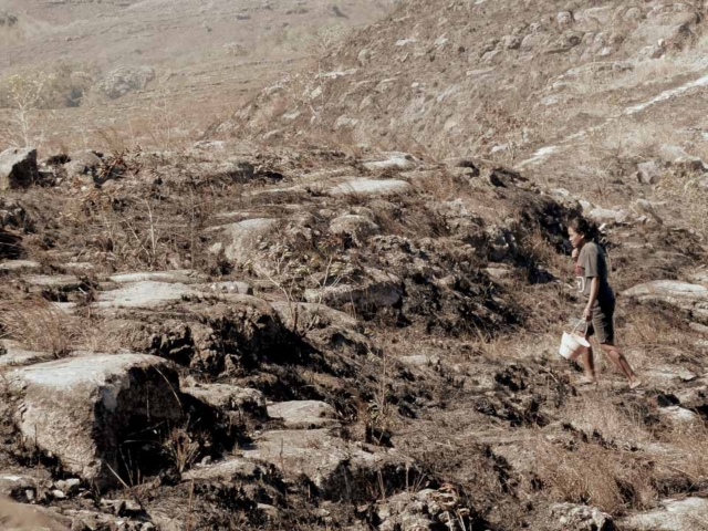 A dry riverbed in an Indonesian village, symbolizing the worsening water crisis due to extreme heat.