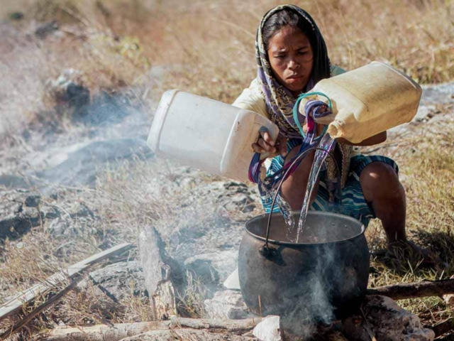 A dry riverbed in an Indonesian village, symbolizing the worsening water crisis due to extreme heat.