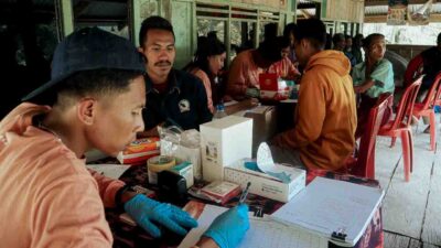 Health workers in rural Indonesia conducting slide-based malaria tests as part of Fair Future’s Kawan Against Malaria program