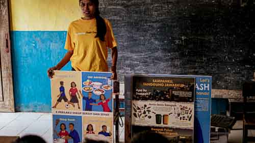 Women from rural villages reading the Kawan Sehat book and learning about healthy living.