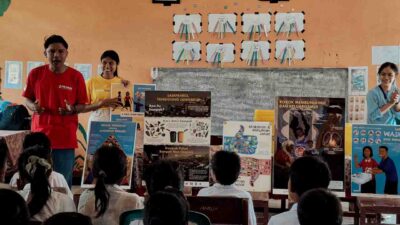 Fair Future educators lead a classroom session with posters on hygiene, health, nutrition, and environmental awareness in a rural school