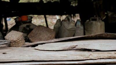 Uncovered jerrycans and containers in Umalulu, creating mosquito breeding risks.