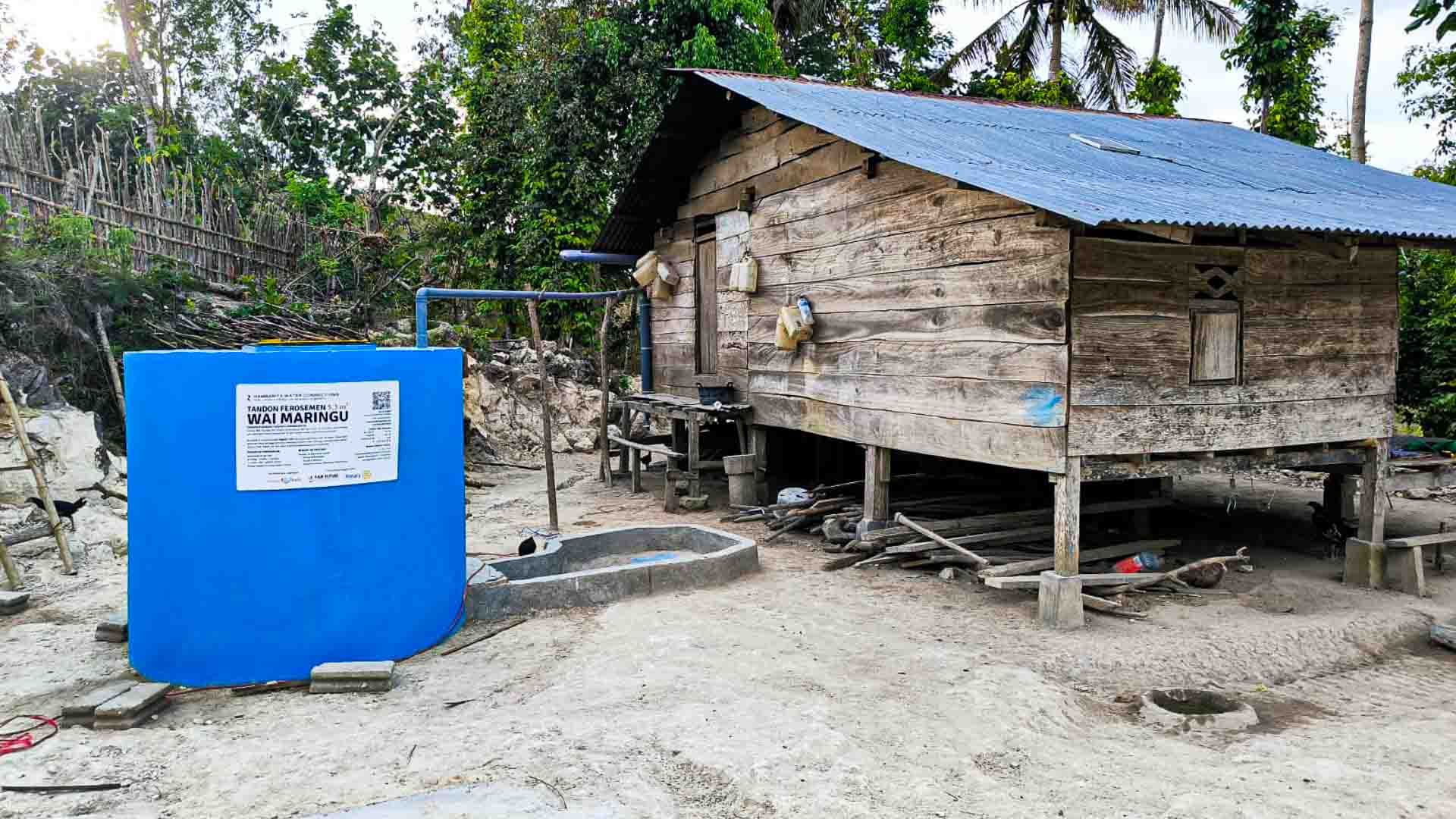 5,300L ferrocement water tank next to a wooden house in Hambarita, East Sumba