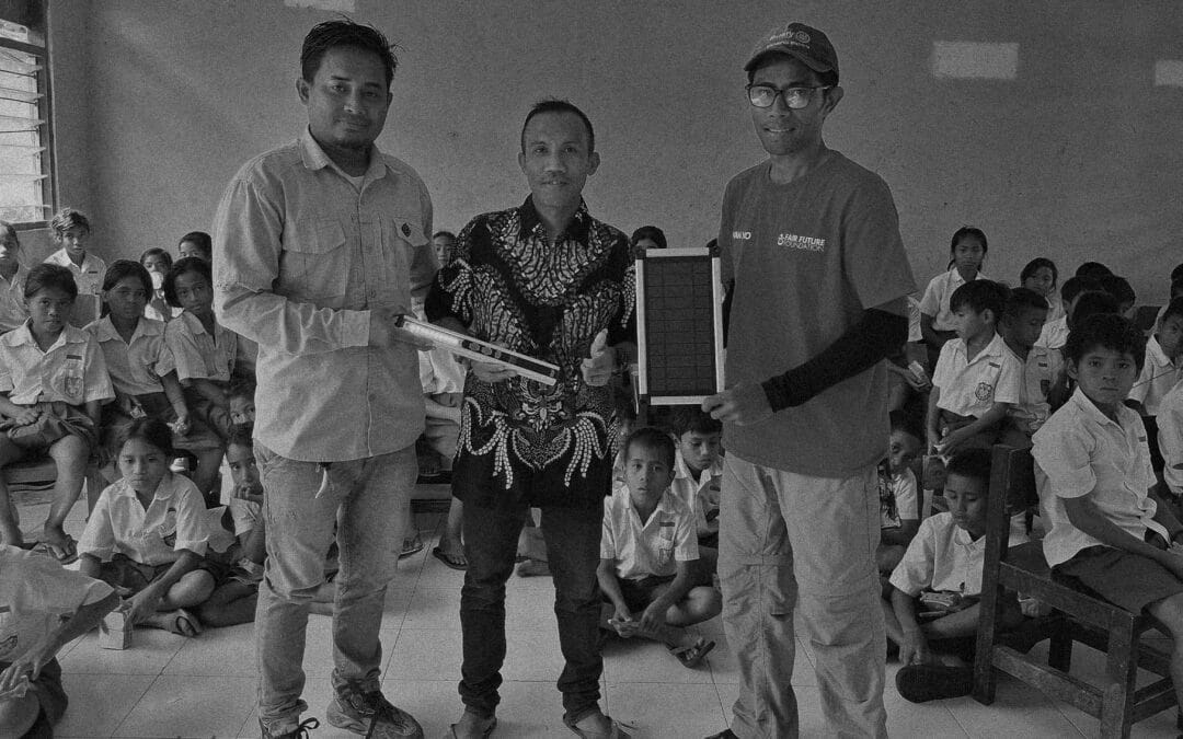 Student holds SolarBuddy lamp during hygiene training in Lataluri