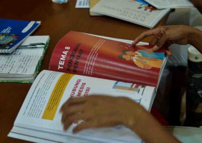 HIV prevention poster explaining transmission and protection for rural families in East Sumba