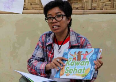 HIV prevention poster explaining transmission and protection for rural families in East Sumba