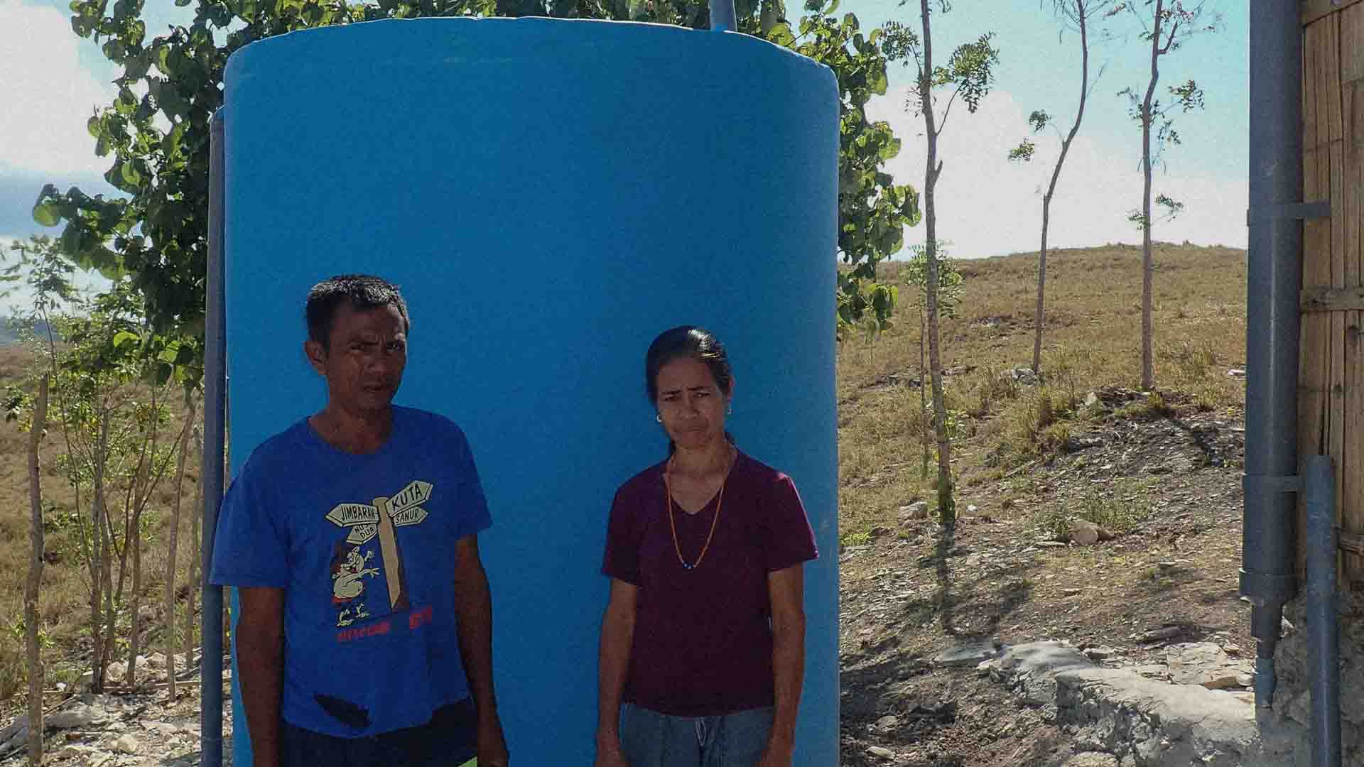 Workers and villagers build and plaster the Wai Pa Luri Wangu water tank for Hambarita clean water access.