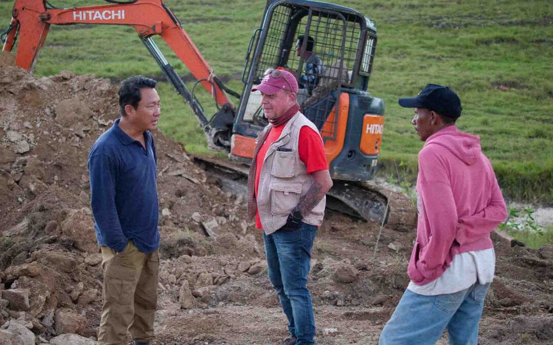 Excavator digging foundations for the clean water reservoir in Laindatang.