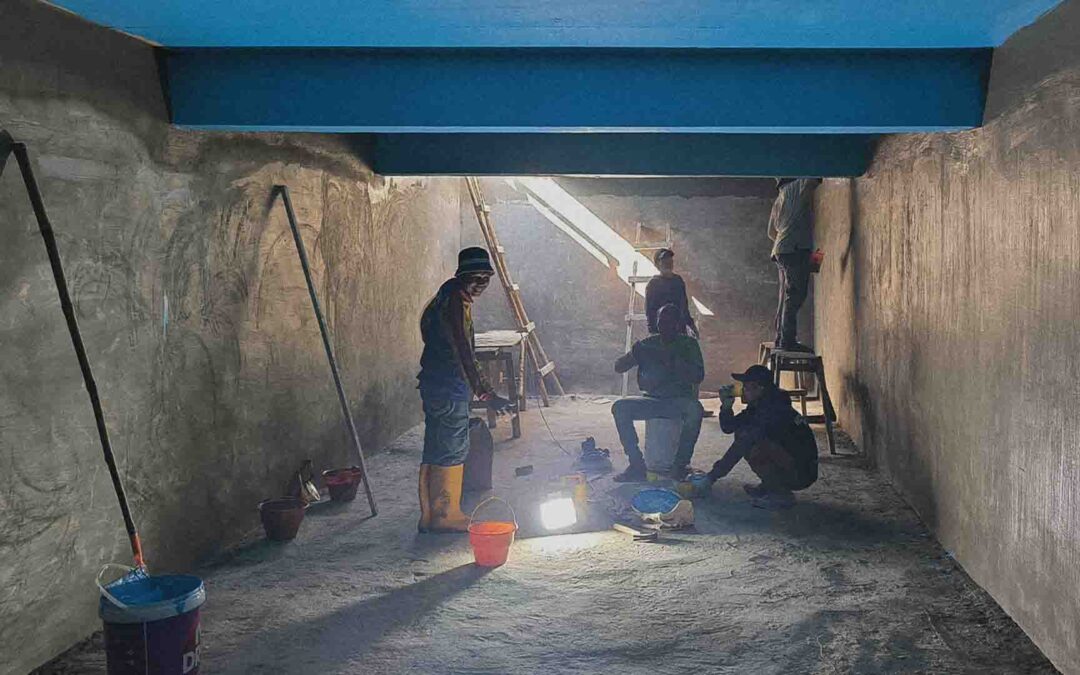 Blue waterproof layer applied inside Laindatang reservoir to secure clean water storage for families