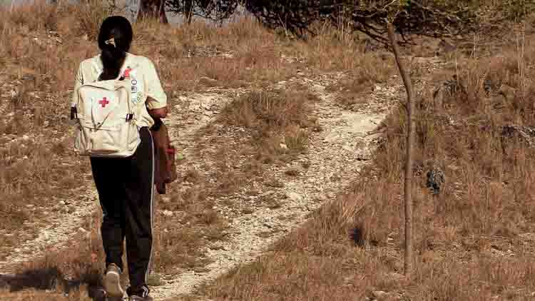 Swiss non-profit medical organisation working in ultra-rural Indonesia Children in rural Indonesia carrying water containers through dry, dusty paths to their home