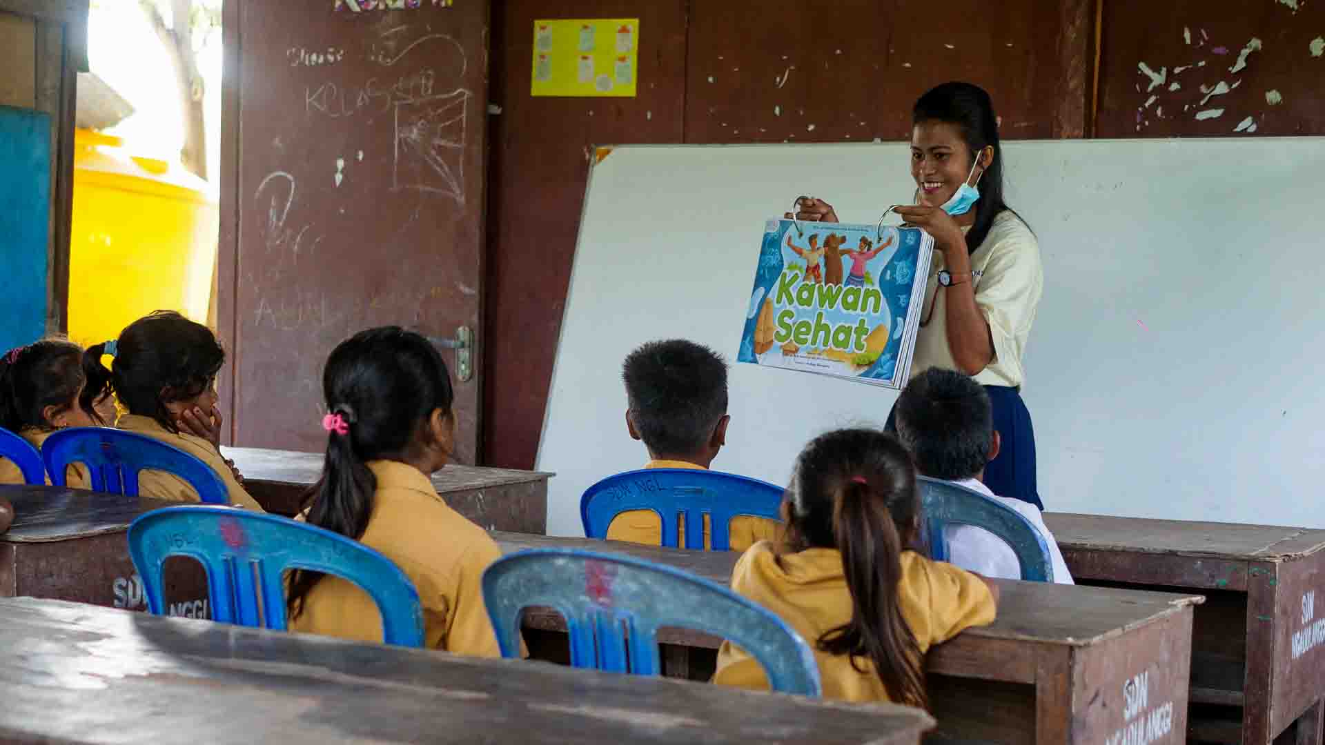 Health education session on disease prevention with children in a rural classroom
