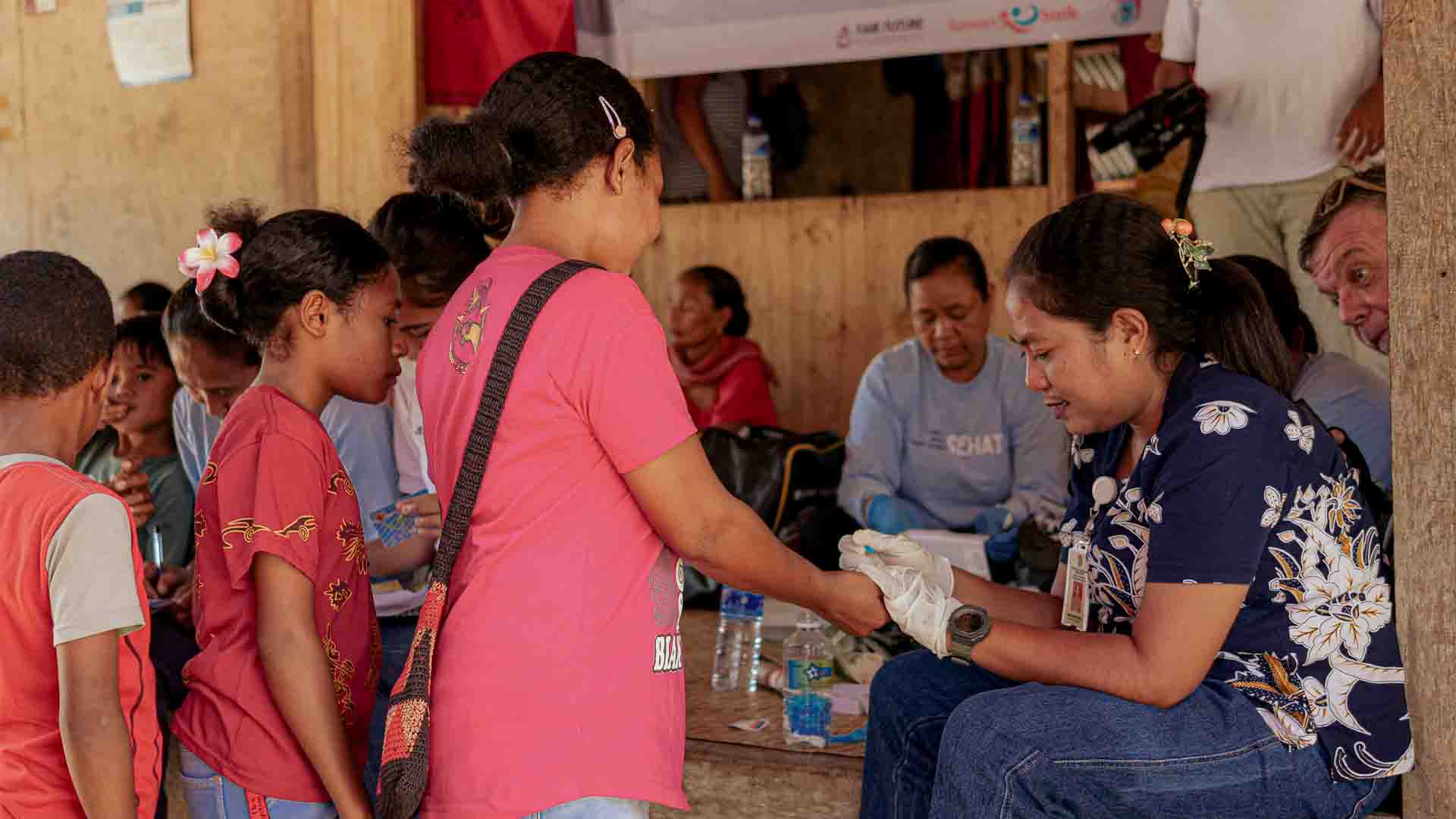 Community health worker treating patient in rural East Sumba village consultation prevention healthcare