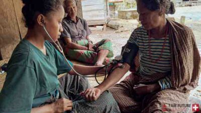 Kawan Sehat health agents from Fair Future Foundation providing primary medical care, wound treatment, blood pressure checks, and health support to children, adults, and elderly people in remote villages of East Sumba, Indonesia.