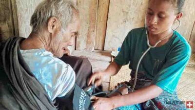 Kawan Sehat health agents from Fair Future Foundation providing primary medical care, wound treatment, blood pressure checks, and health support to children, adults, and elderly people in remote villages of East Sumba, Indonesia