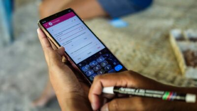 Hands holding a smartphone displaying the Sumba Sepsis Study 2026 survey app during field data collection.