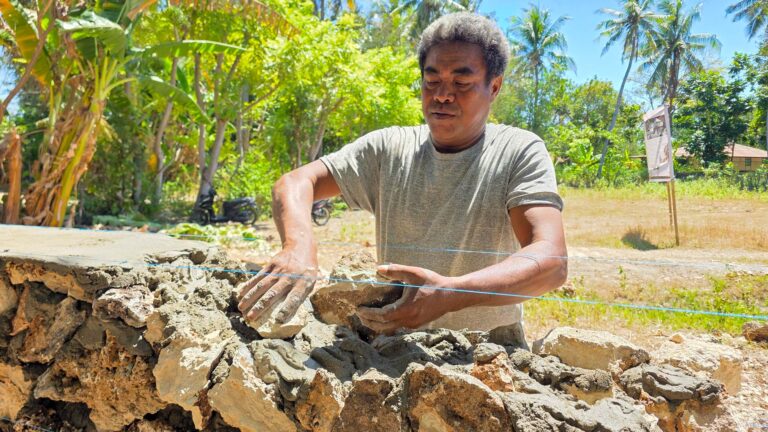 A local mason builds the stone boundary wall at the future Rumah Kambera Health and Community Centre in Kawangu, East Sumba