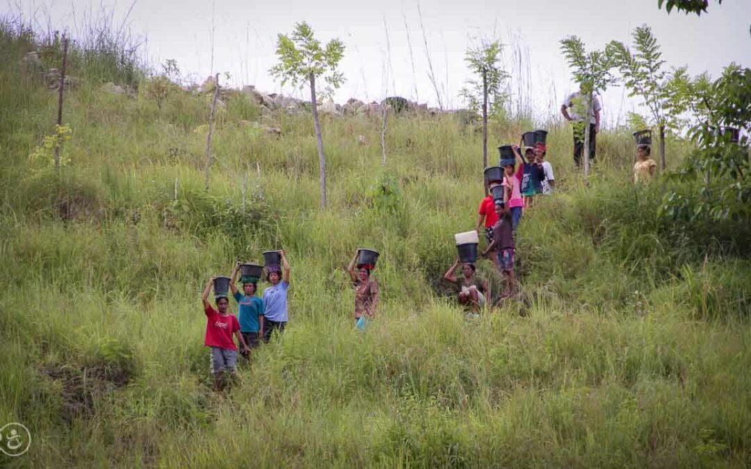 Strong women carry sand for the construction of a new clean water tank