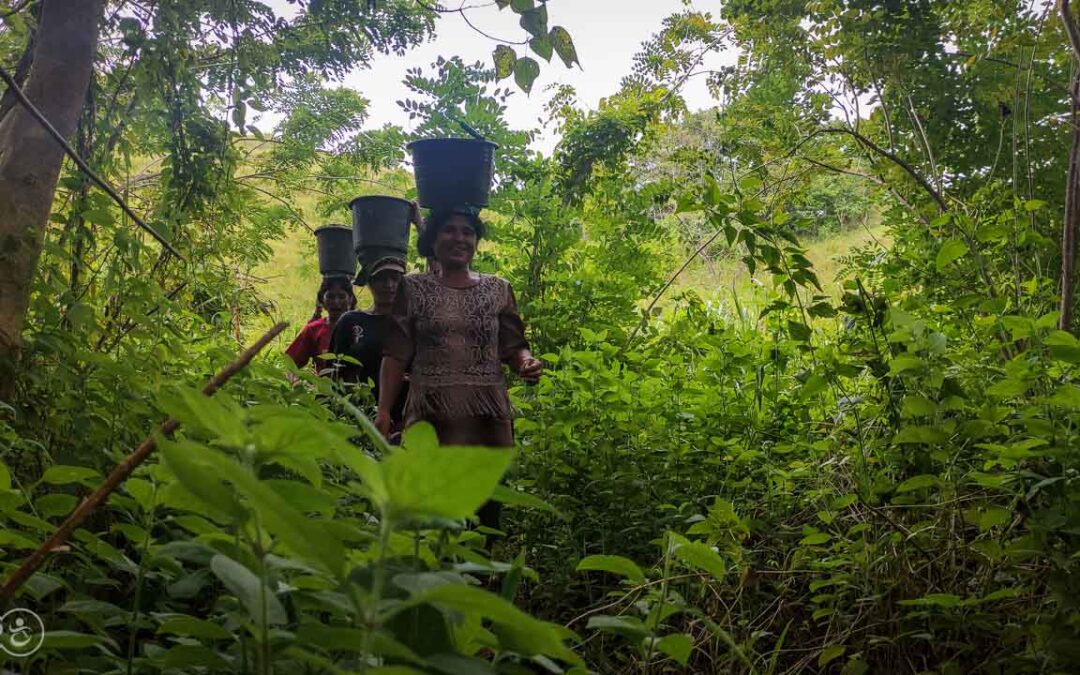 Strong women carry sand for the construction of a new clean water tank