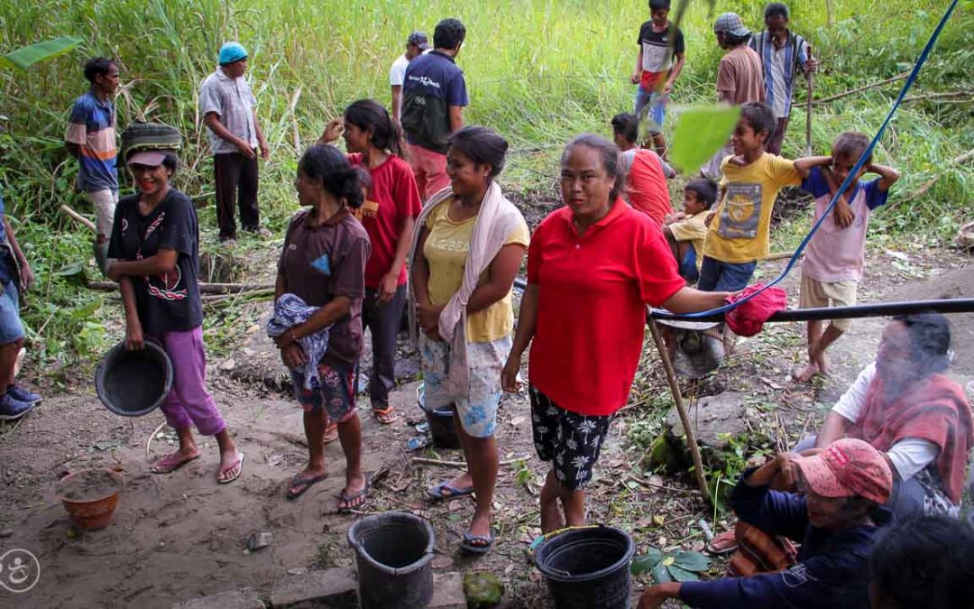 Strong women carry sand for the construction of a new clean water tank