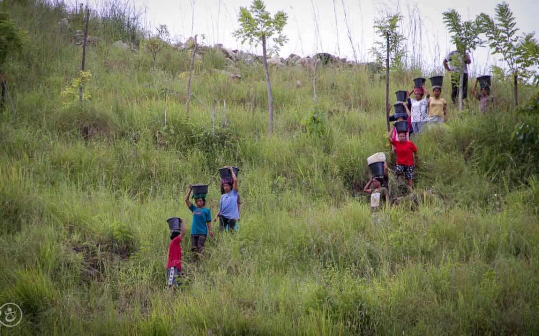 Strong women carry sand for the construction of a new clean water tank