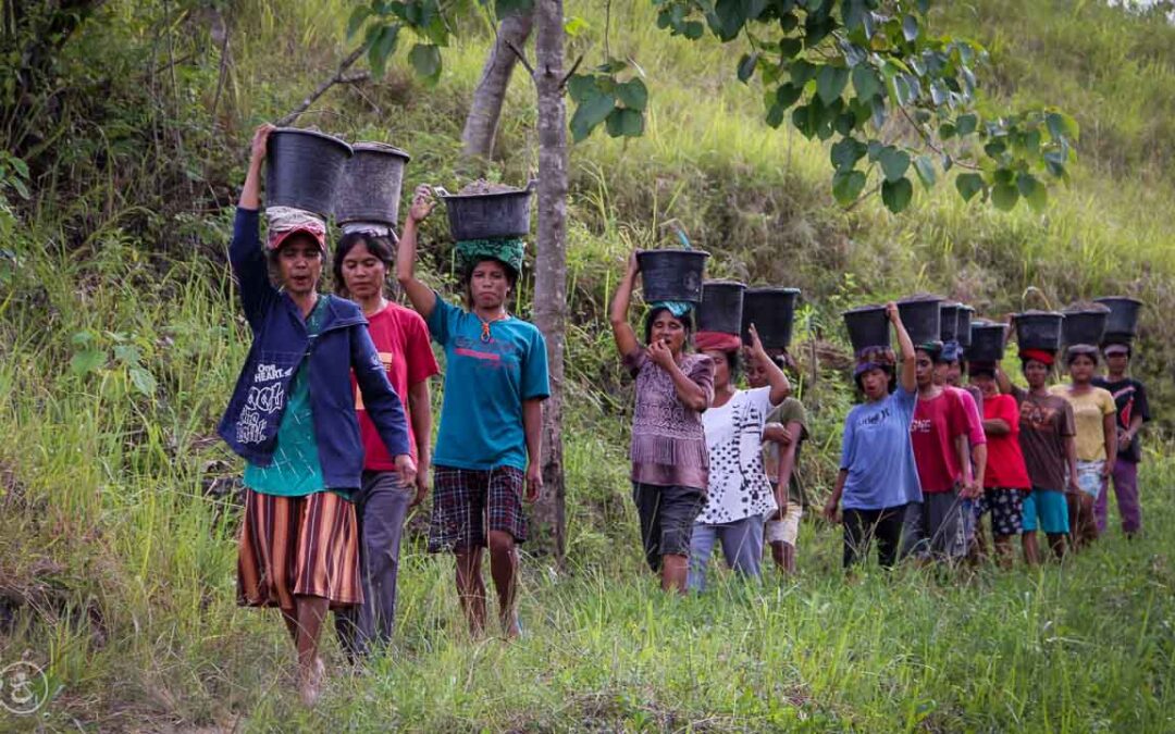 Strong women carry sand for the construction of a new clean water tank