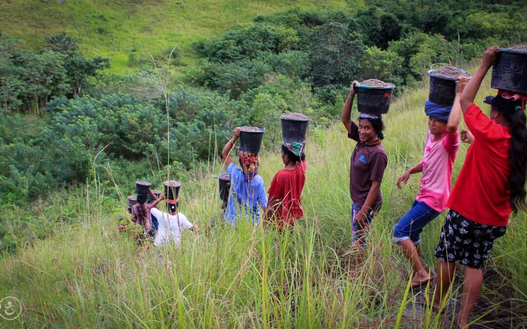 Strong women carry sand for the construction of a new clean water tank