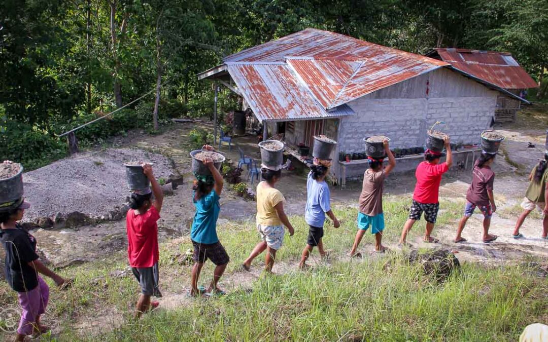 Strong women carry sand for the construction of a new clean water tank