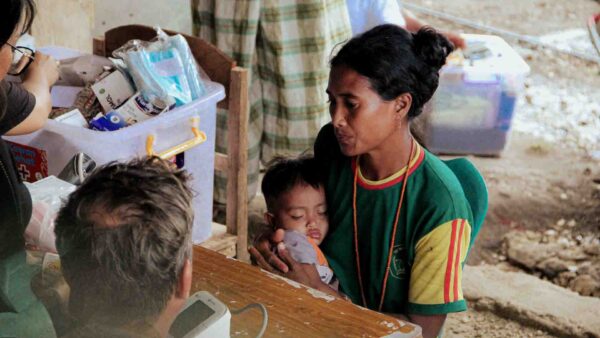 Mother and child during a rural medical consultation in Eastern Indonesia with limited healthcare access