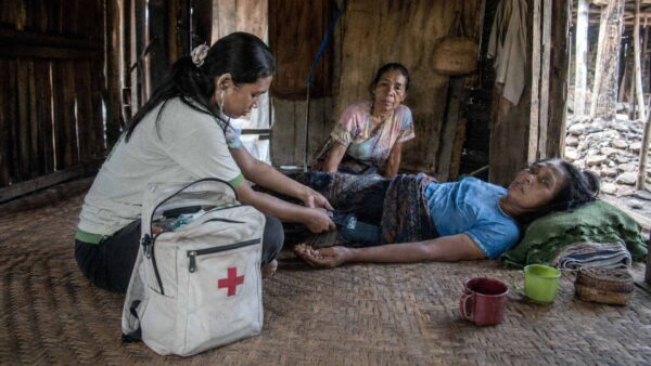 Kawan Sehat health agent checking a sick patient at home during the East Sumba Sepsis Study.